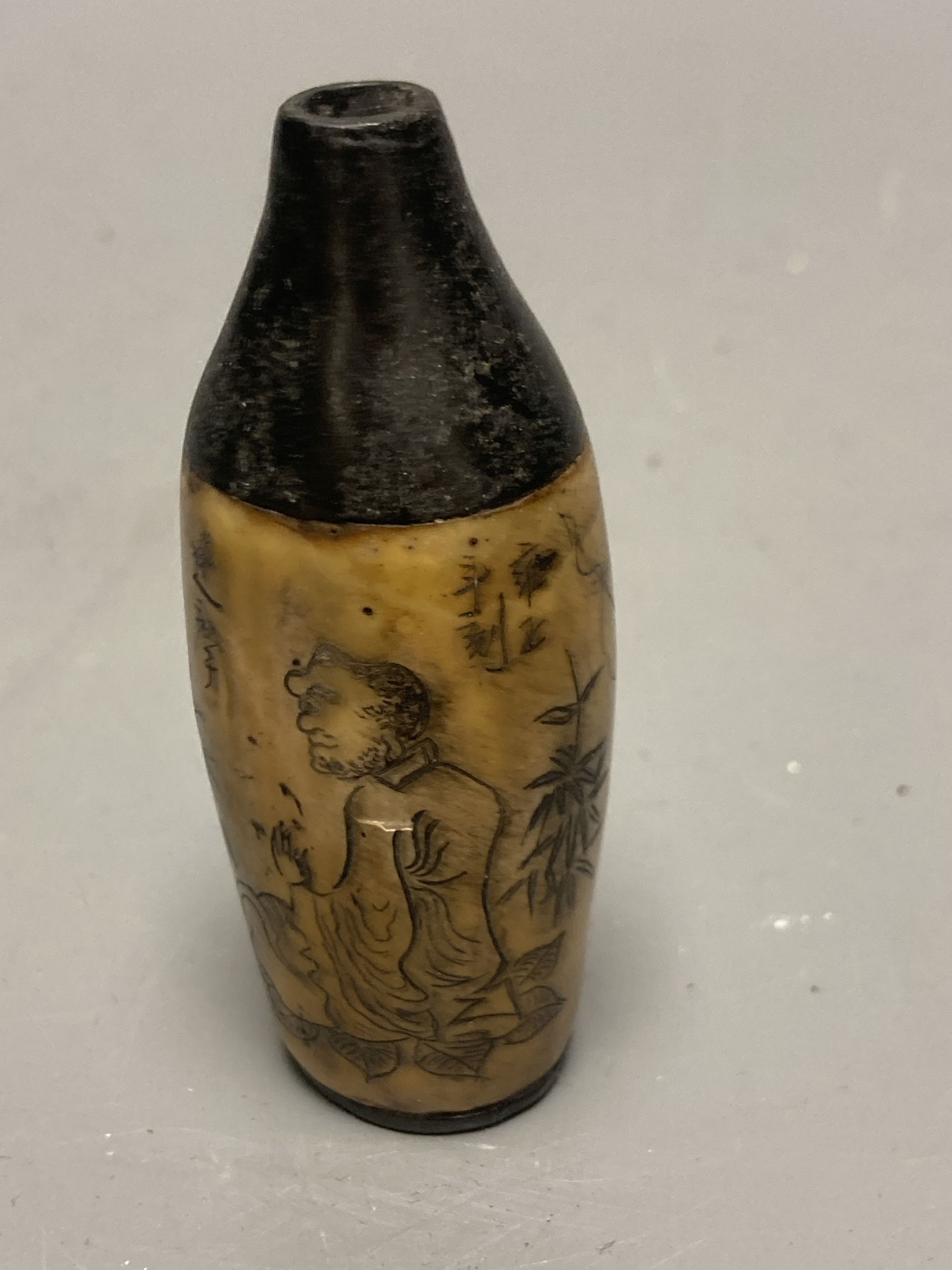 Two Chinese snuff bottles, one with erotic carving, tallest 7cm
